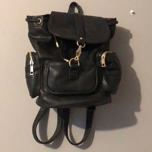 Black faux leather backpack with gold